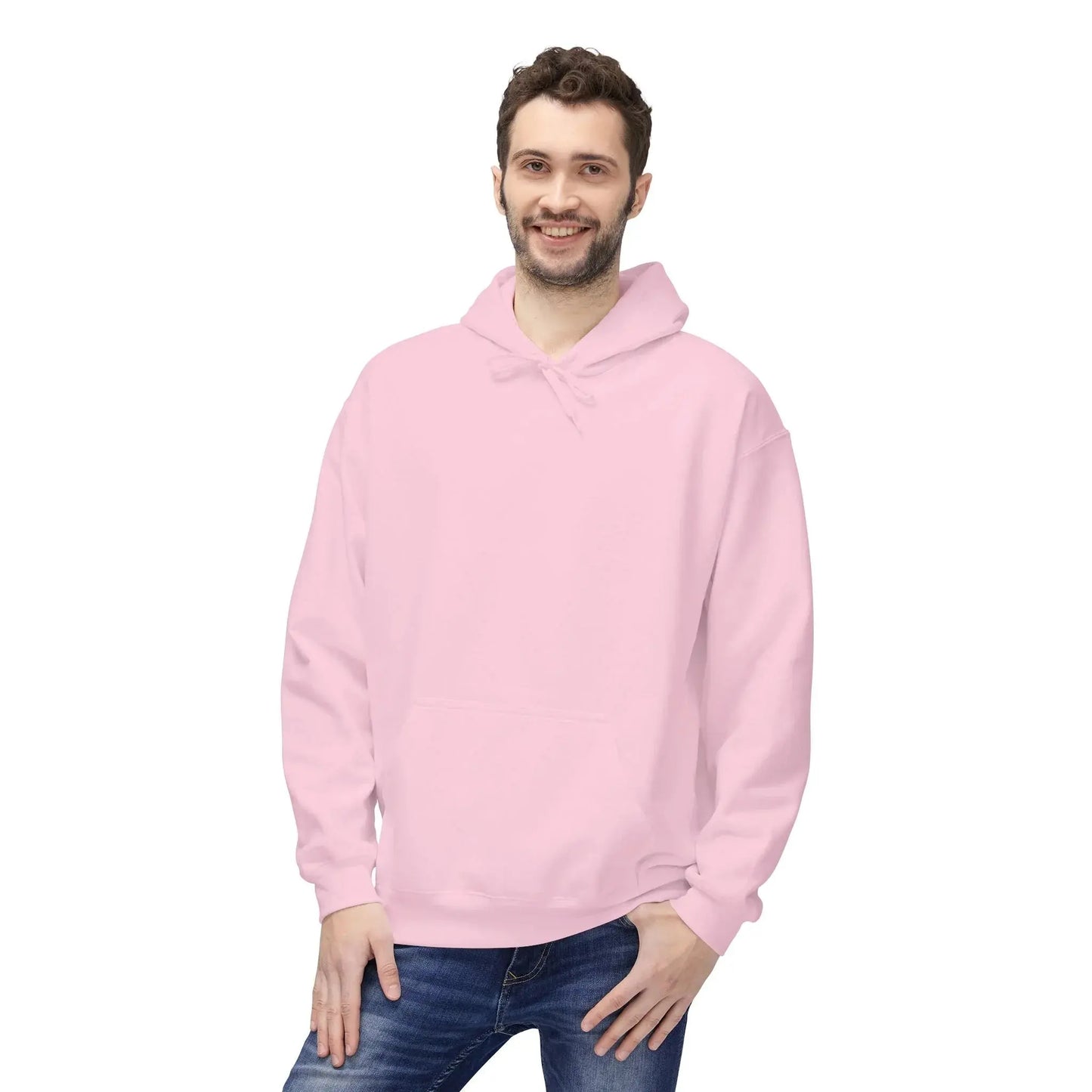 Man wearing a light pink hoodie and blue jeans on a white background