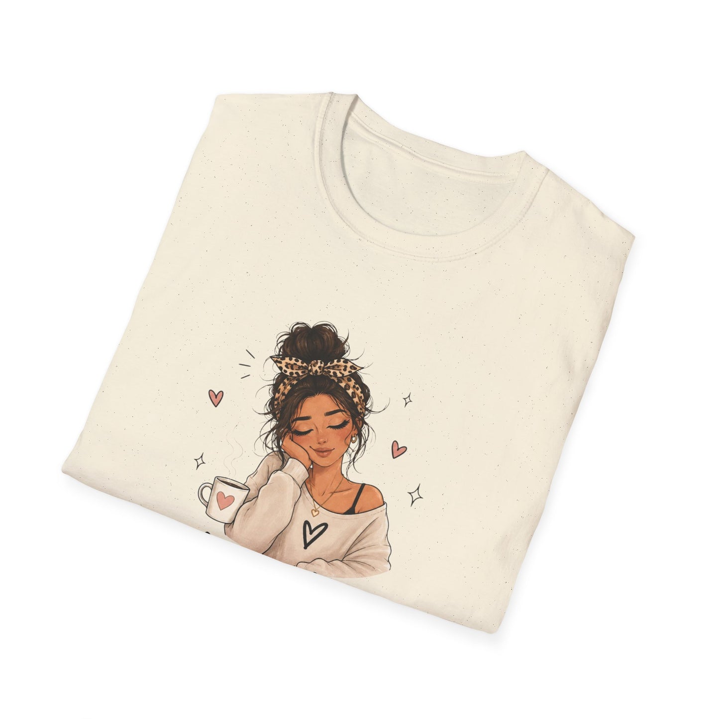 Folded beige sweatshirt with a graphic of a woman holding a coffee cup on a white background