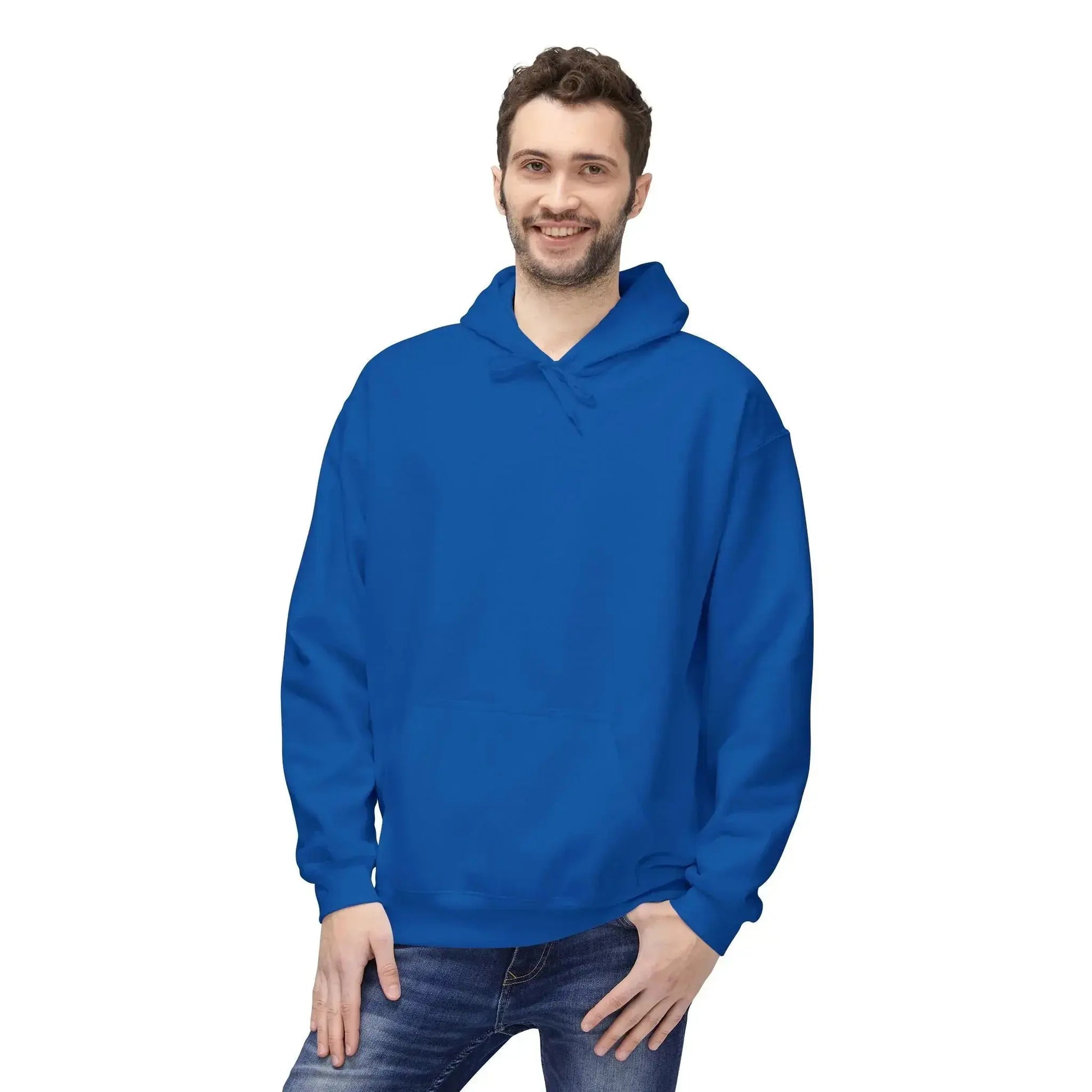 Man wearing a plain blue hoodie and jeans, standing against white background