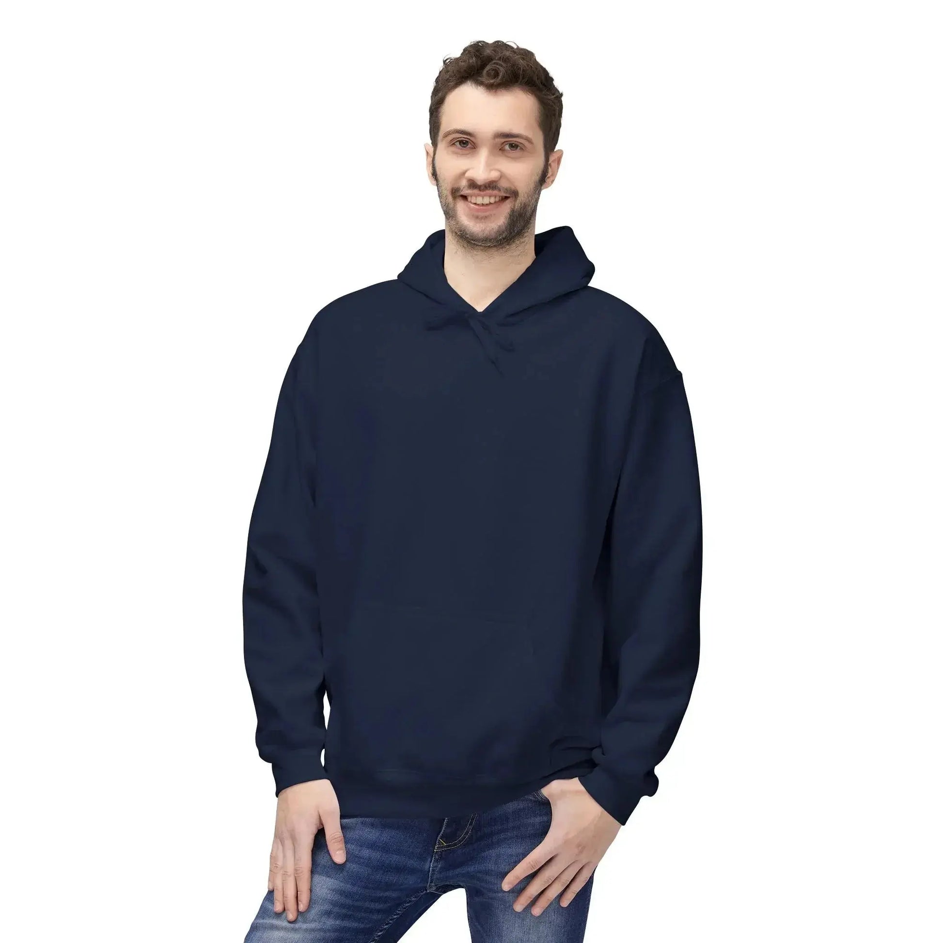 Man wearing a plain navy blue hoodie and jeans on a white background