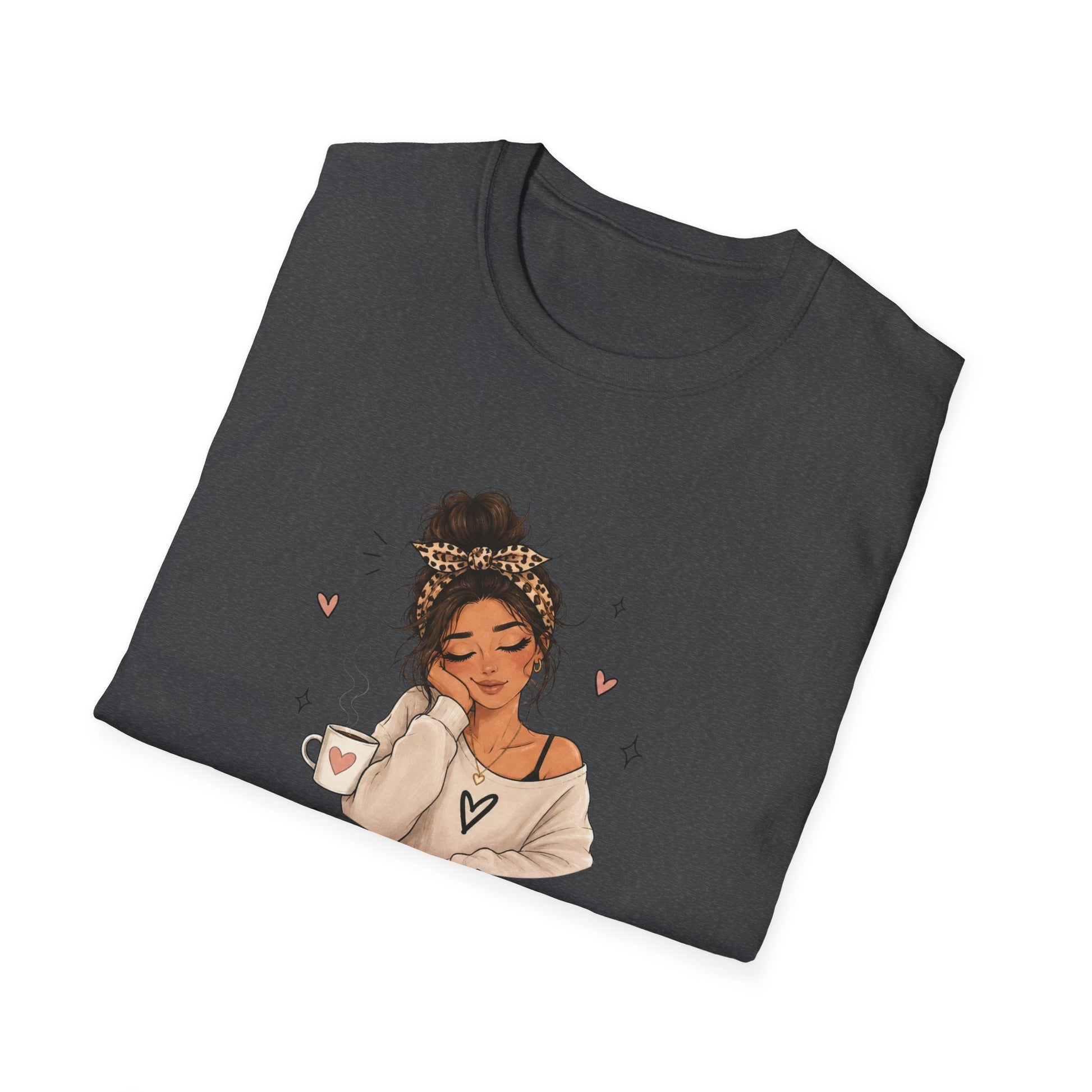Folded dark gray t-shirt with an illustration of a woman holding a mug on a white background
